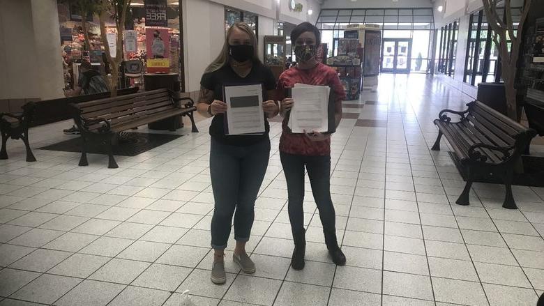 Students, Tamara Seltzler, left, and Paige Pleta distributing surveys to members of the community.